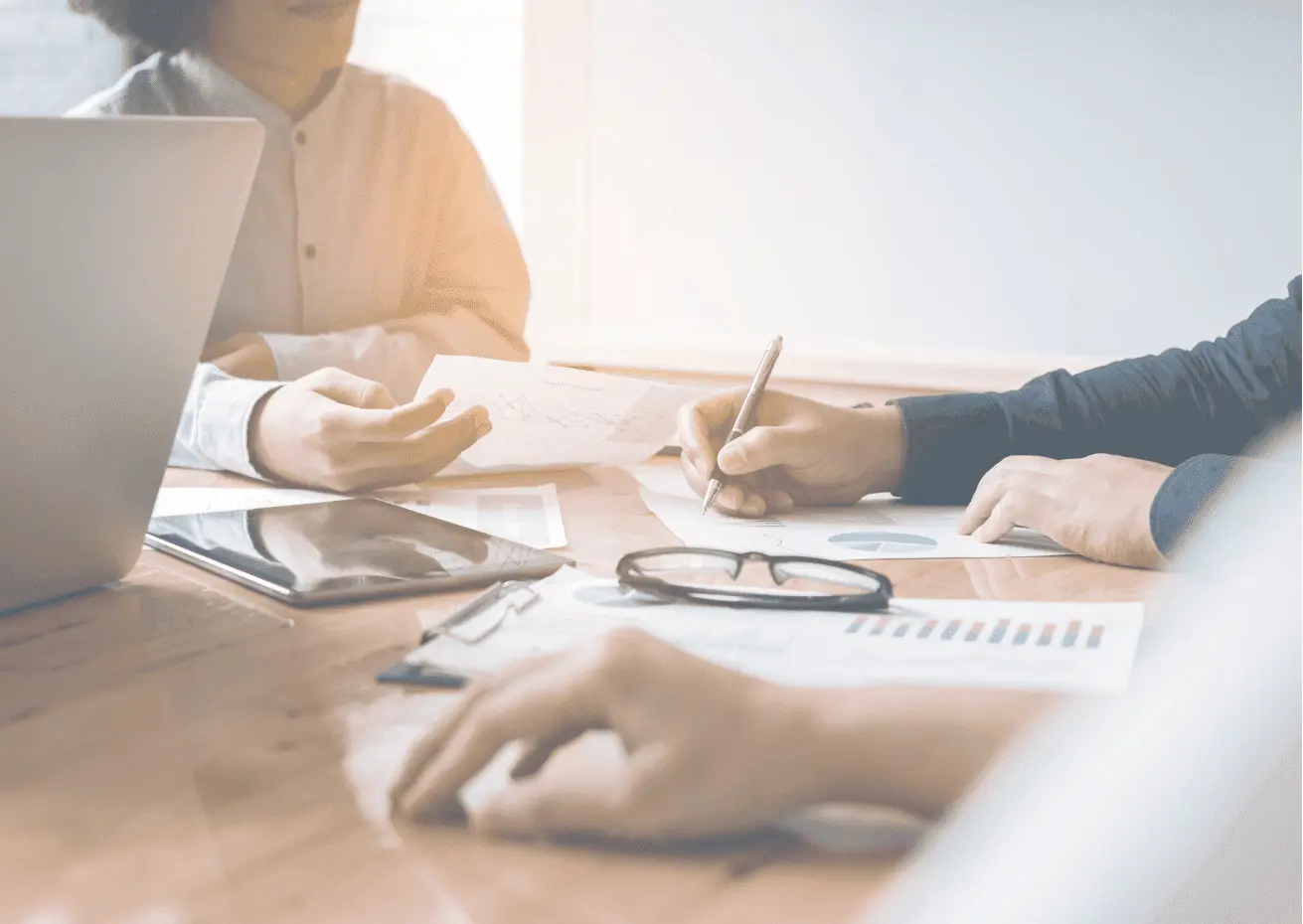 Advisers reviewing SMSF actuarial certificate requirements at a meeting table.